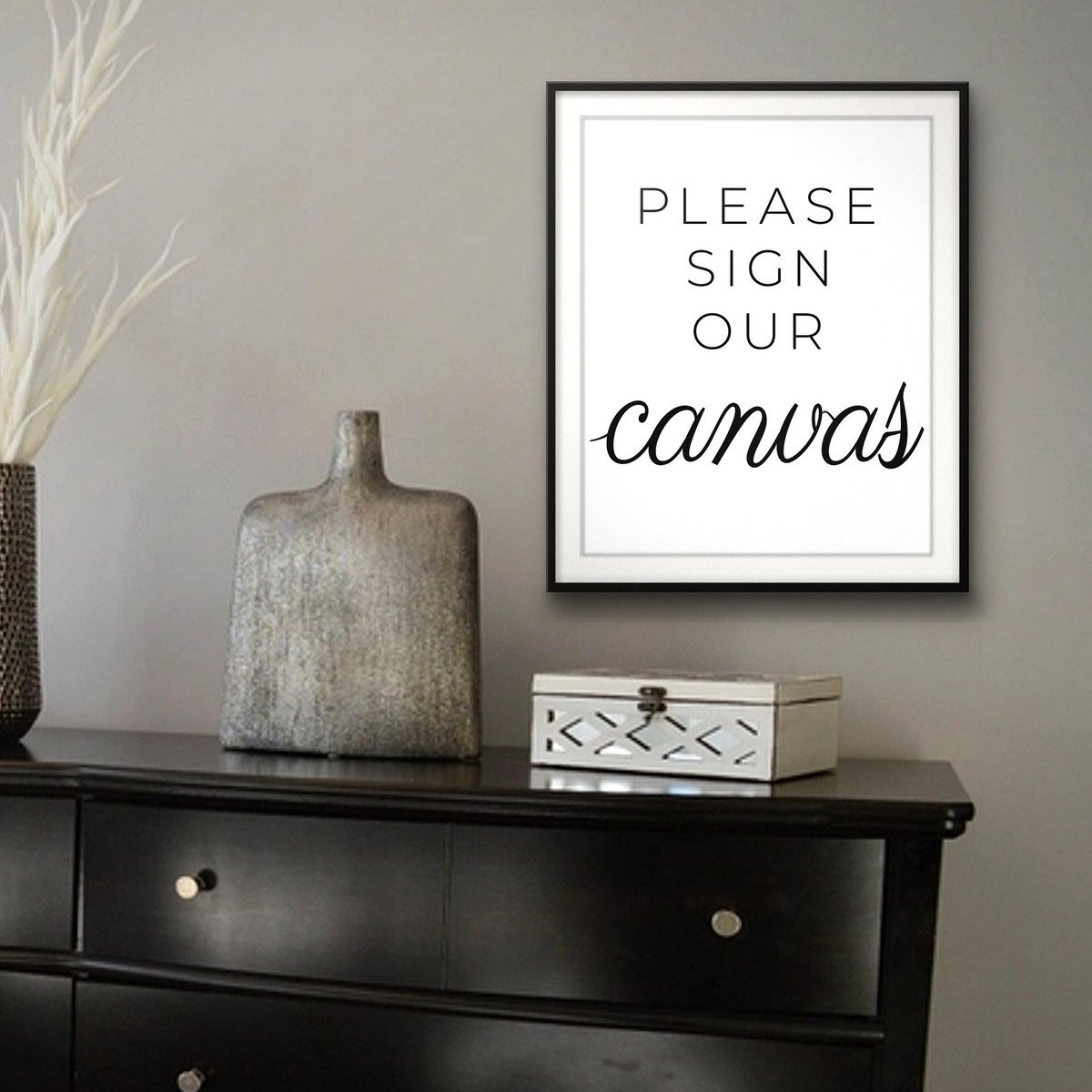 Please Sign Our Canvas shown framed on a wall